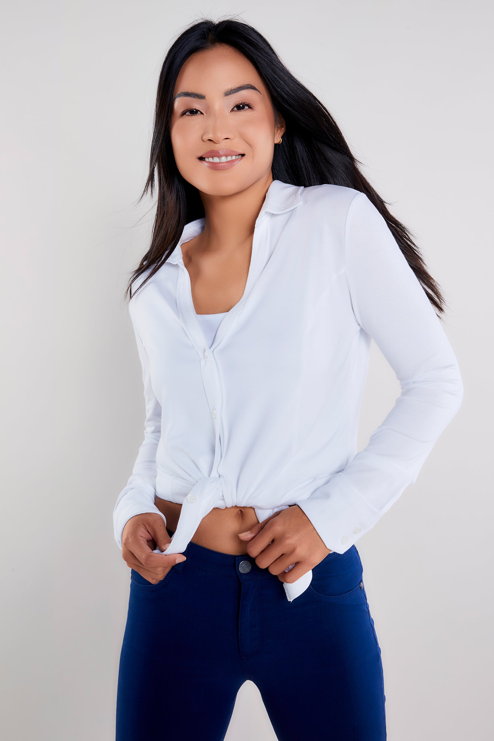 The Best Travel Shirt. Woman Showing the Front Profile of a Nikki Longsleeve Jersey Shirt in White