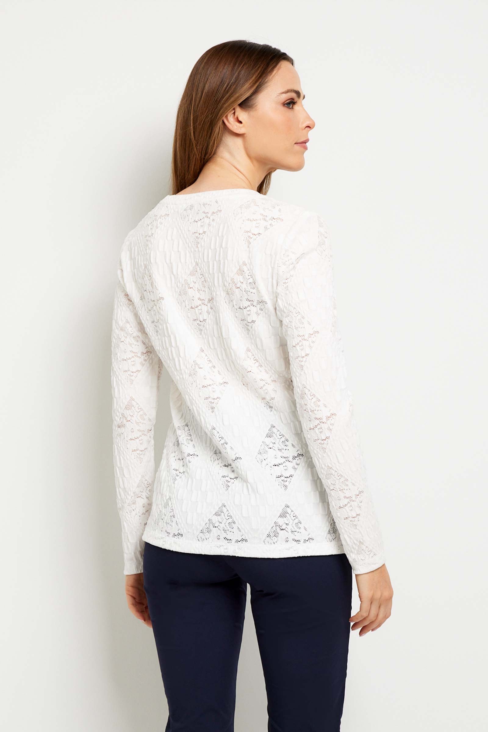 The Best Travel Top. Woman Showing the Back Profile of a Lace Juliana Top in White.