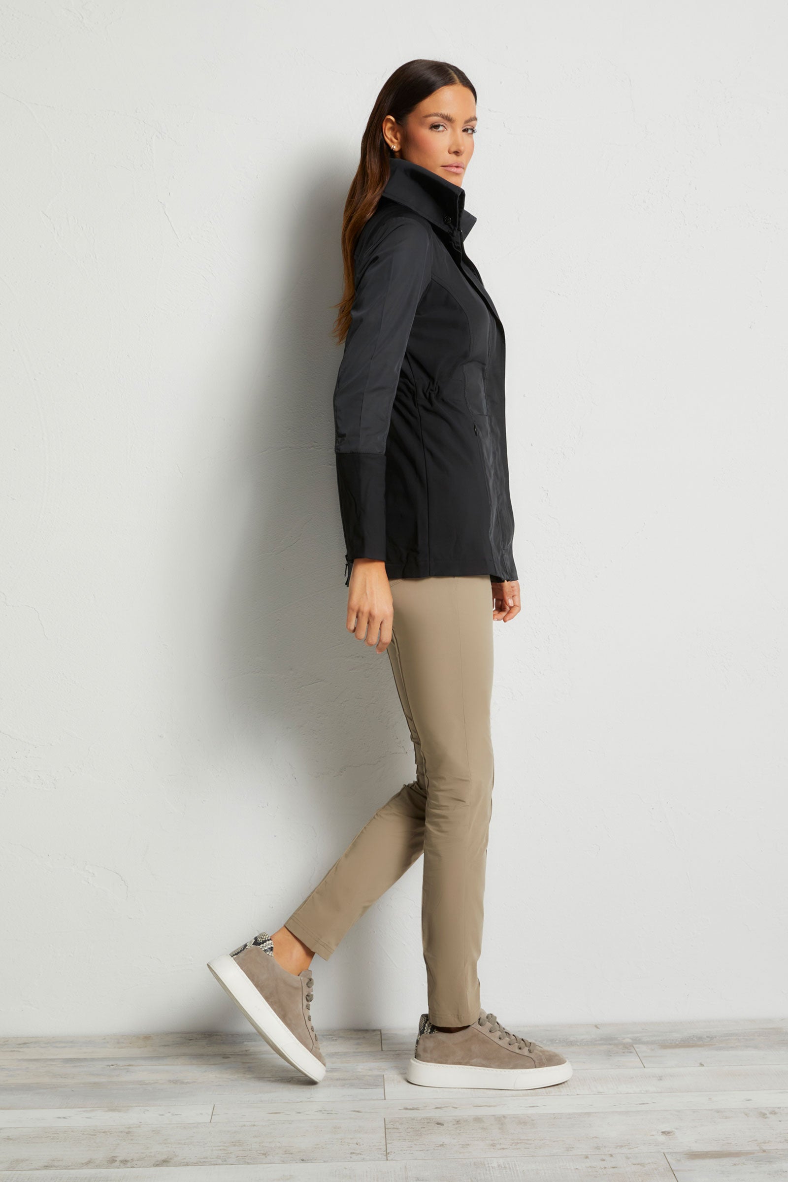 The Best Travel Jacket. Woman Showing the Side Profile of a Travel City Slick Jacket in Black