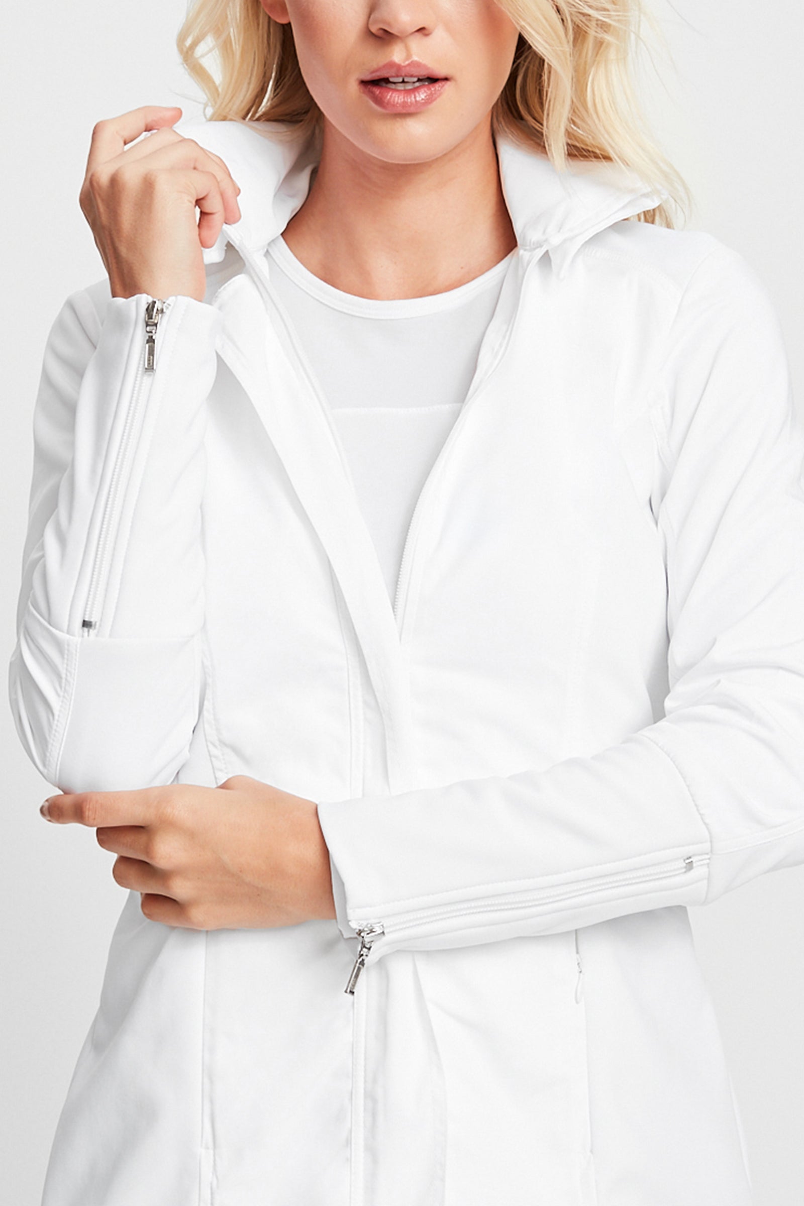 The Best Travel Jacket. Woman Showing the Front Profile of a Travel City Slick Jacket in White